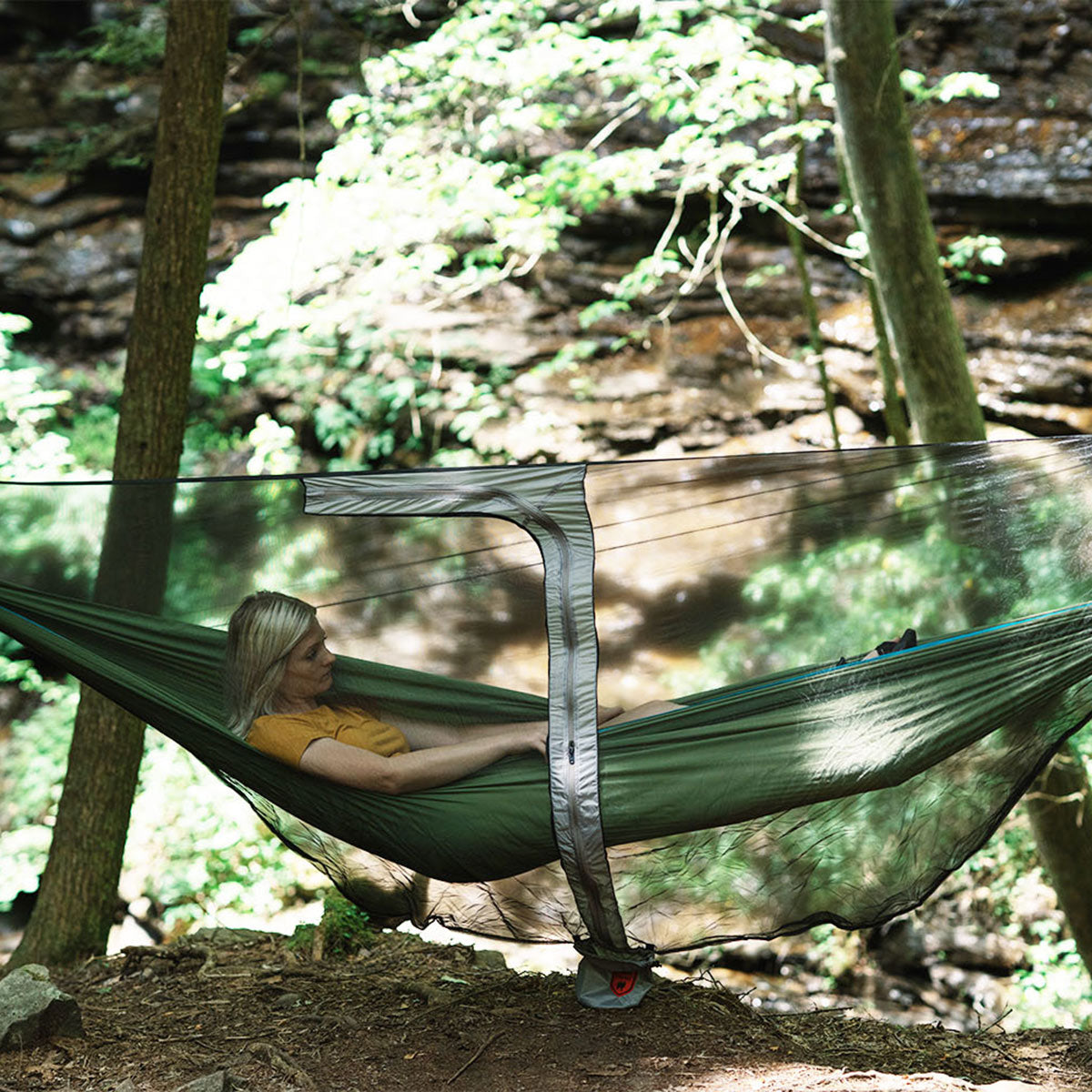 GrandTrunk MOZZY LITE Hammock Bug Net draped over a hammock, showcasing its fine mesh design for insect protection.