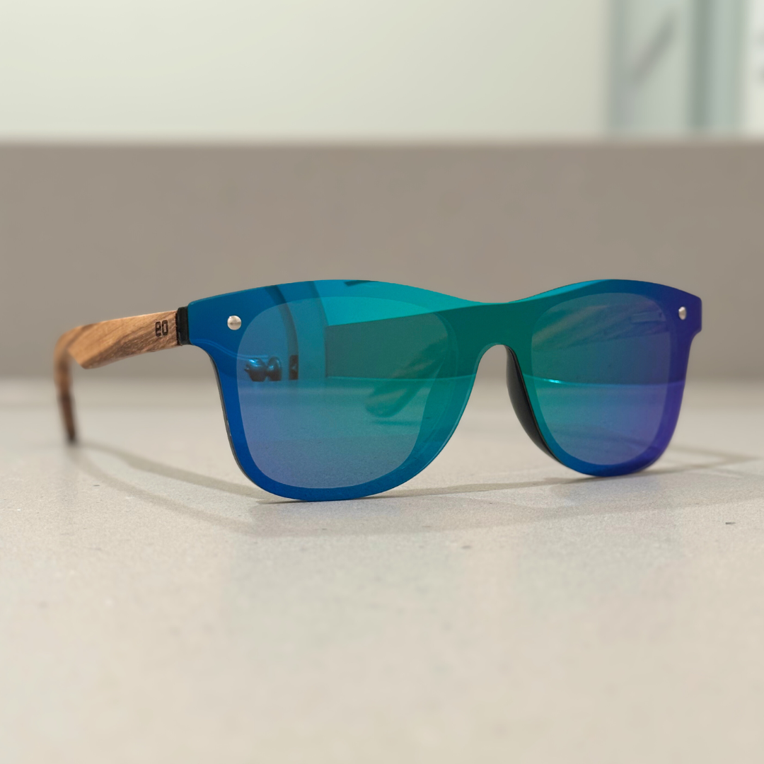 Eastern Outer Natalia sunglasses in zebrawood, featuring green-tinted lenses and stylish angular design.