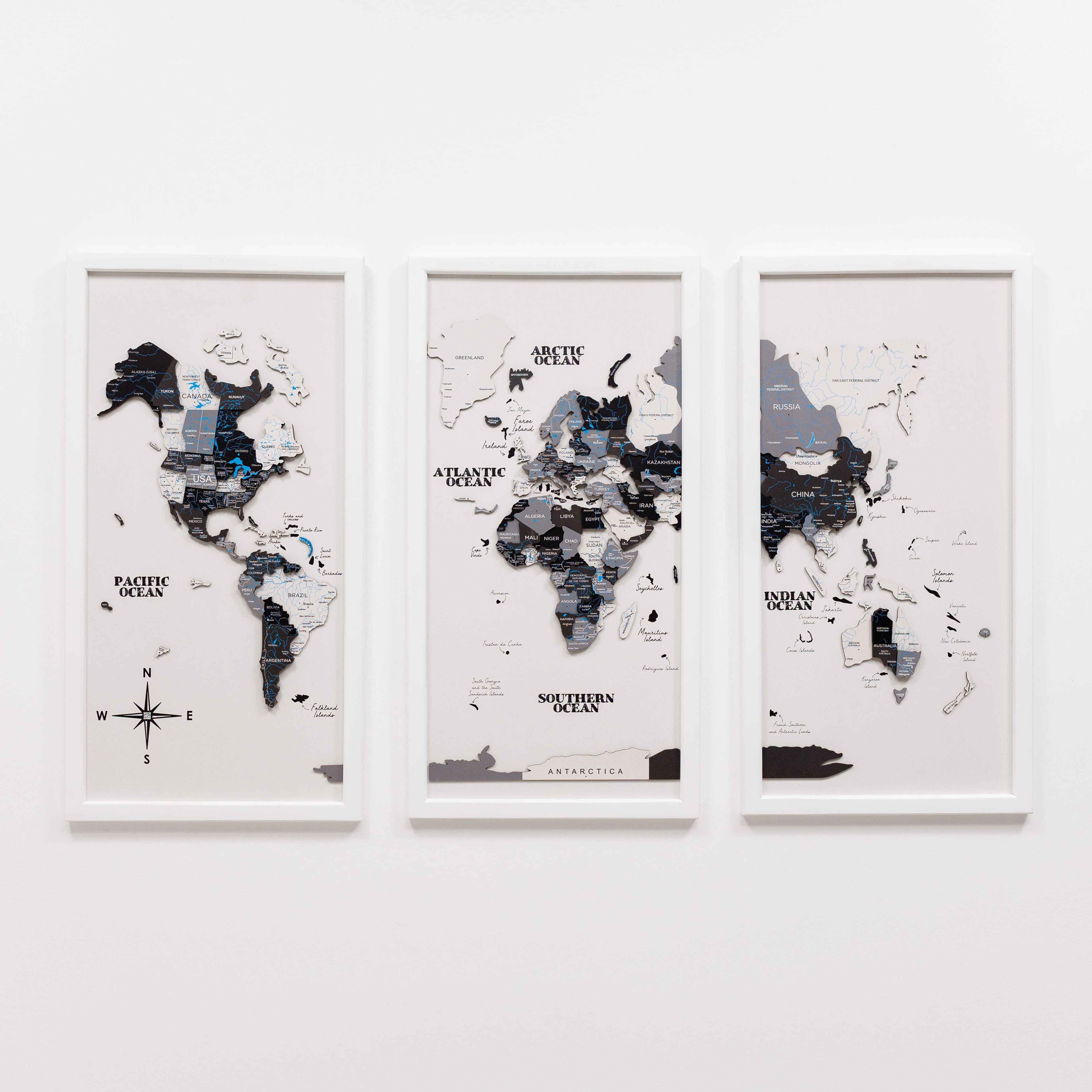 Wooden triptych wall art featuring a detailed world map with a Nordic-inspired design by Enjoy The Wood, displayed in three panels.