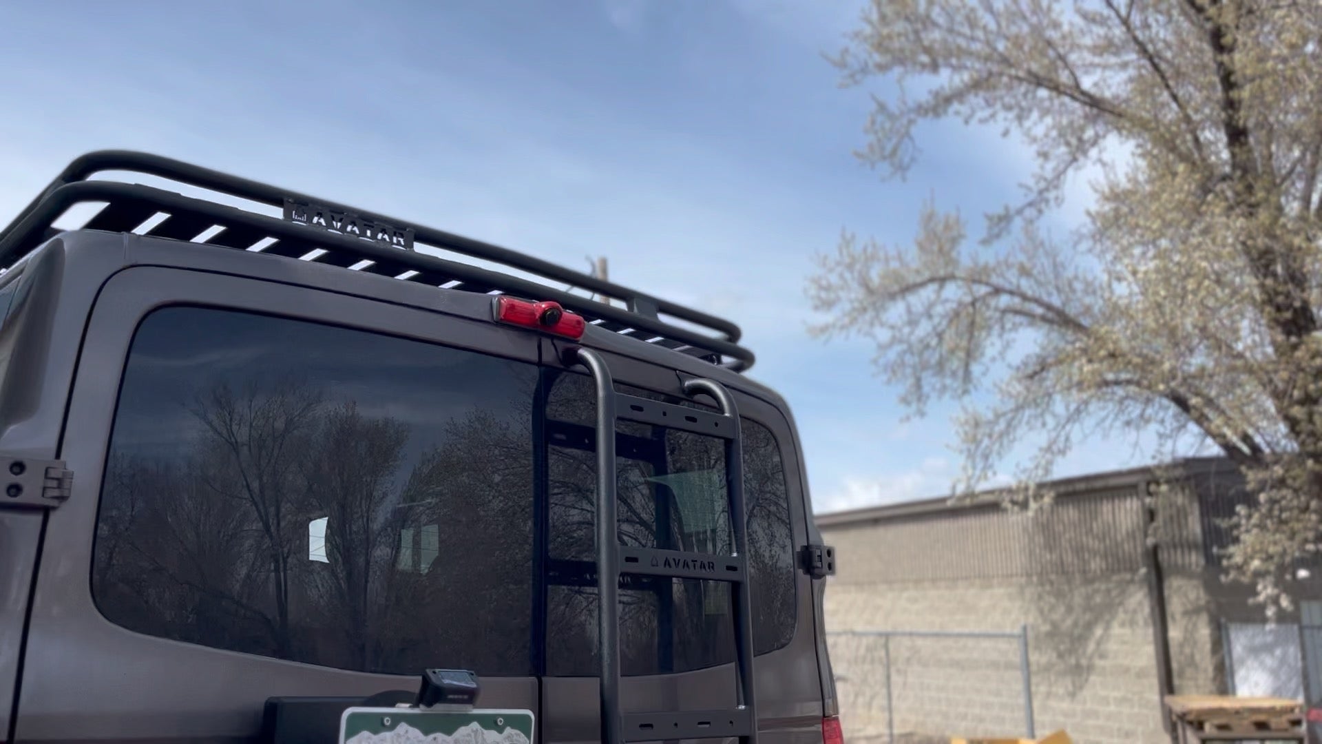 Avatar Offroad NV3500 rear ladder mounted on a van bumper, showcasing sturdy construction and design.