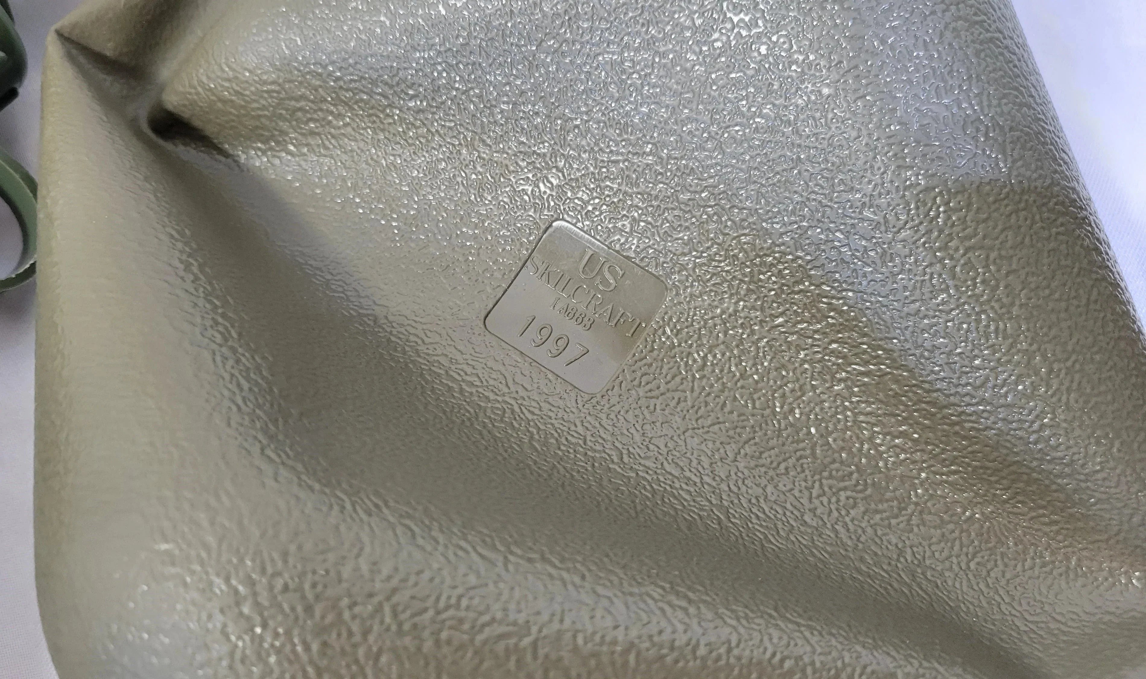 Onethiefsurplus 2-quart canteen with a metal cap and durable nylon cover, ideal for outdoor activities and camping.