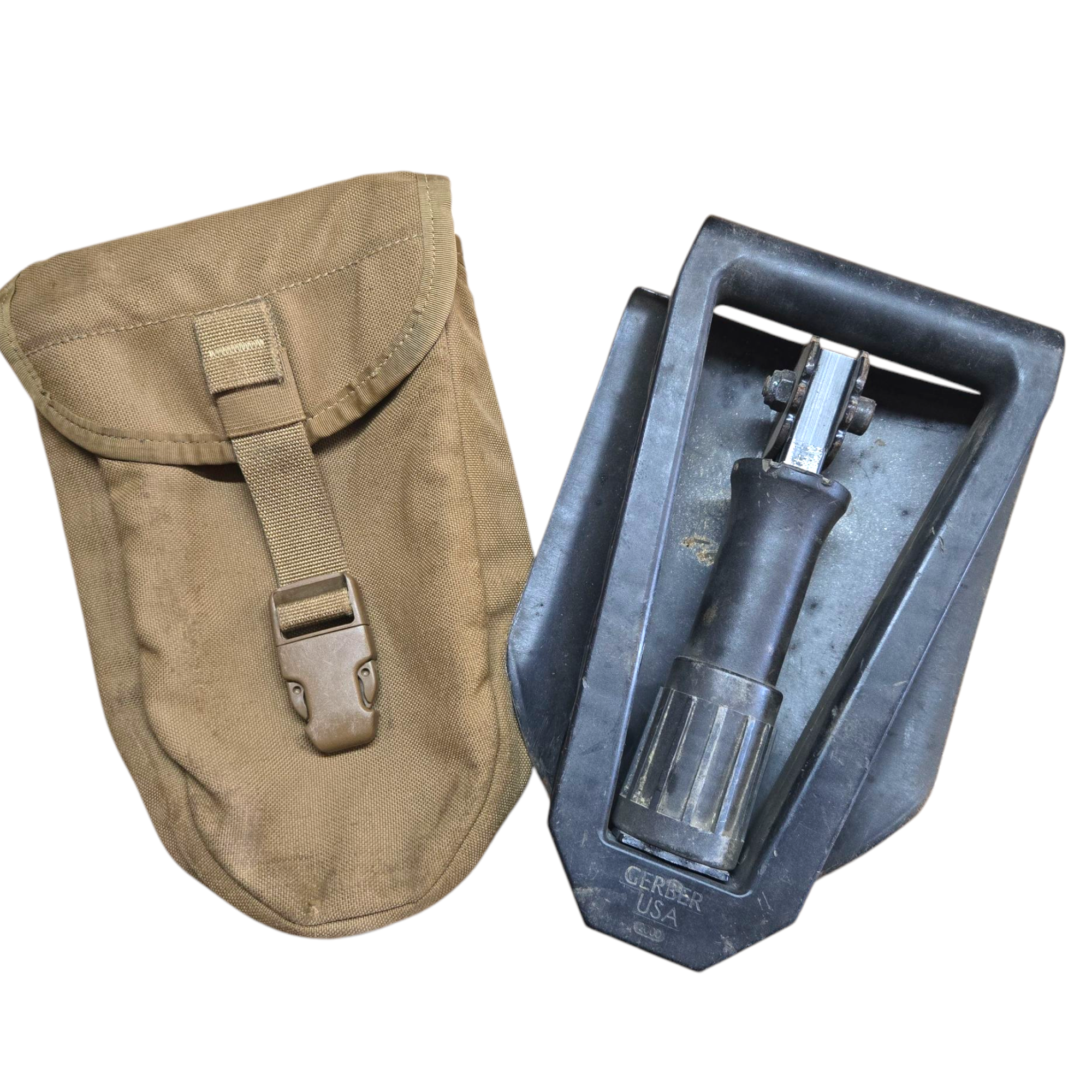 USMC Gerber 2000 entrenching tool for camping and hiking, shown with handle and metal blade in a rugged outdoor setting