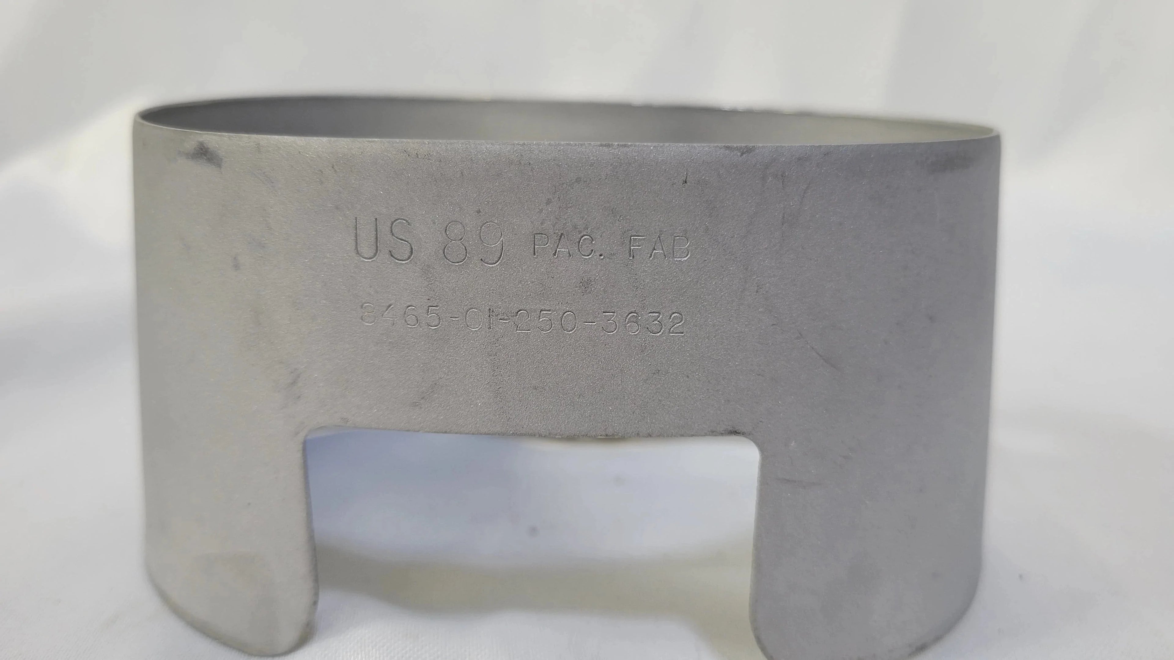 Onethiefsurplus canteen cup stove with metal cup and compact design for outdoor camping and cooking.