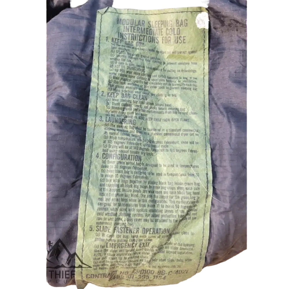 Black intermediate sleeping bag by onethiefsurplus, shown rolled up with zipper and insulation details visible.