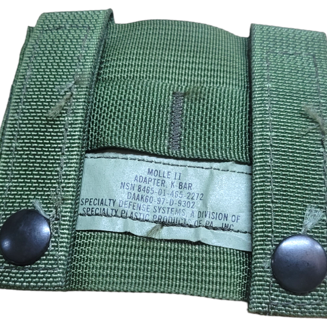 Onethiefsurplus K-Bar MOLLE Adapter attached to a tactical gear setup, showing durable nylon construction and secure attachment points.