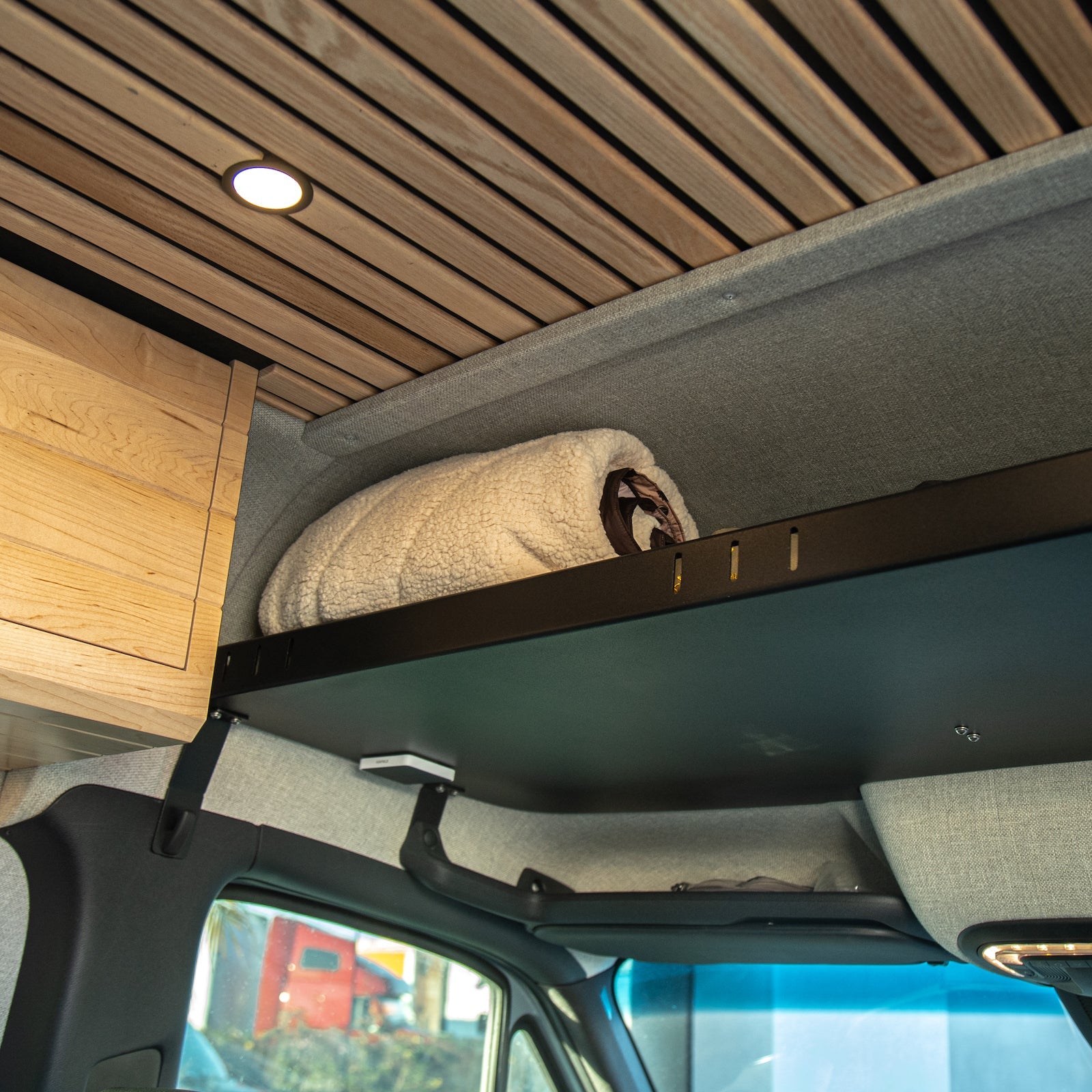 Sprinter headliner shelf from The Van Mart's VanSpeed DIY Collection, showcasing a sleek, functional design for van interiors.