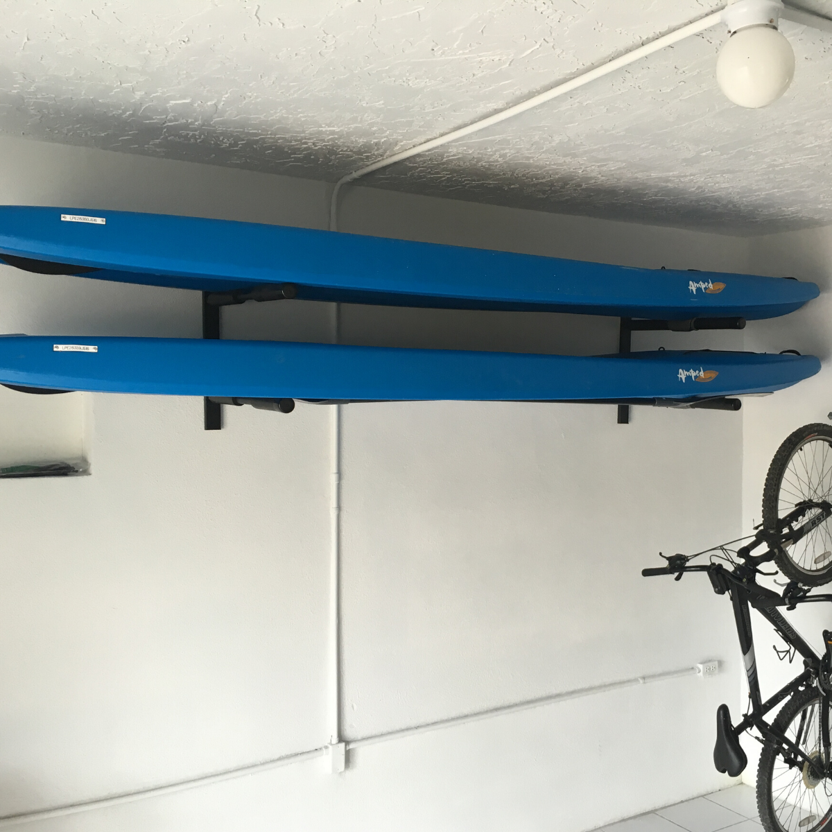 COR Surf double SUP and longboard paddleboard wall storage rack holding two surfboards securely on a wall.