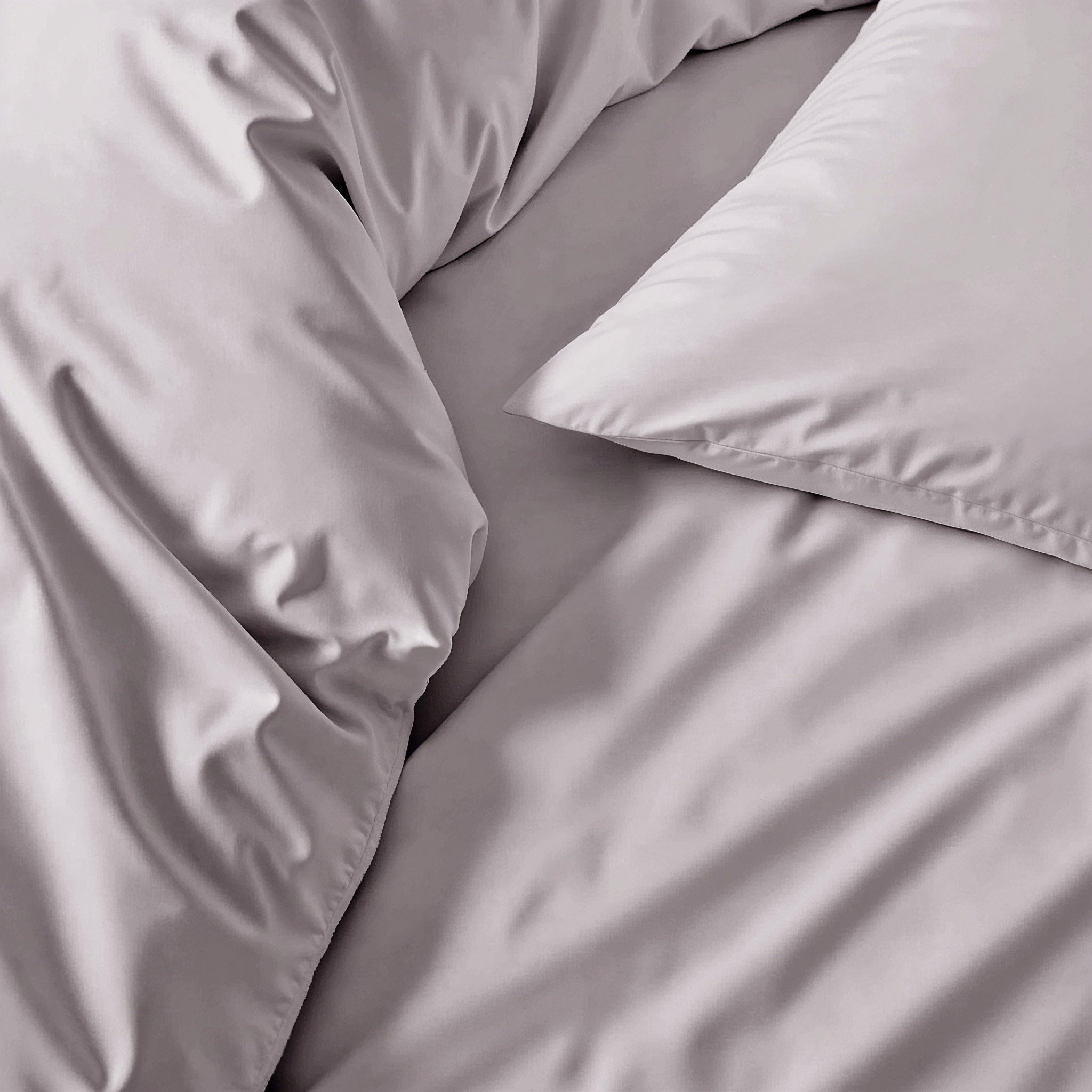 Gray Luxe Australian Sateen duvet cover from Italic, showcasing smooth, luxurious fabric and elegant pebble gray color for a stylish bed.