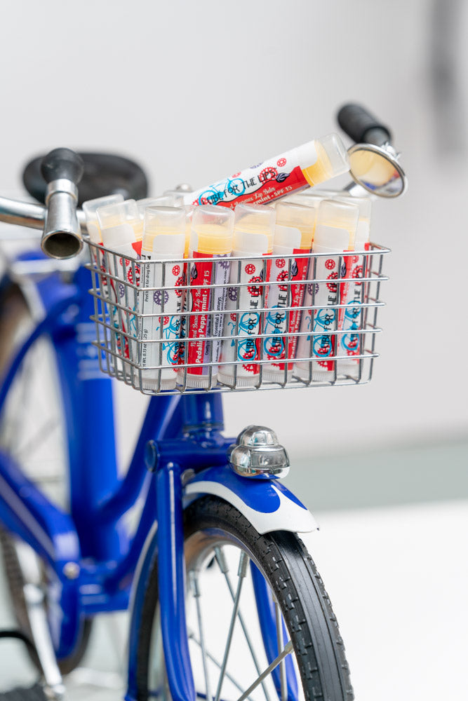 Essential Journeys Pedaling Peppermint SPF 15 Lip Lube tube with peppermint flavor, designed for lip hydration and sun protection.