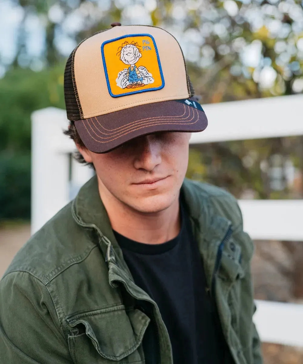 Peter Grimm Peanuts Pig Pen brown trucker cap with mesh back and adjustable strap, casual headwear for fans of Peanuts characters.