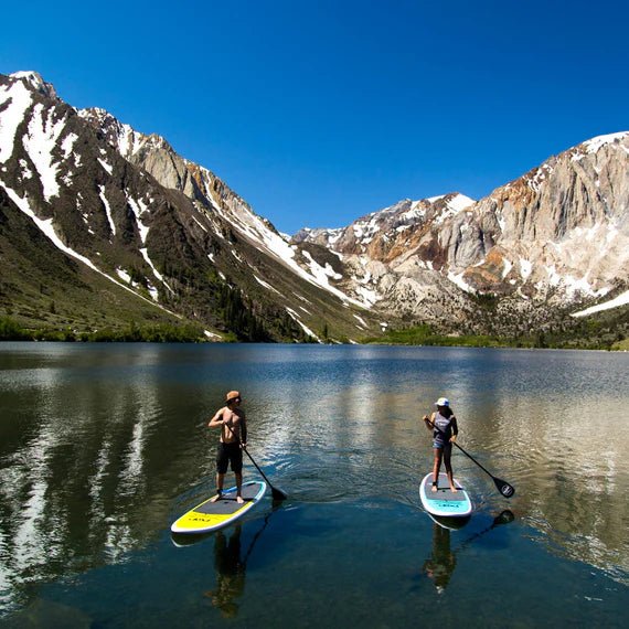 Backcountry Sportsman 10'6" Amigo Wood paddleboard on Convict Lake, showing the wooden finish and paddling setup.