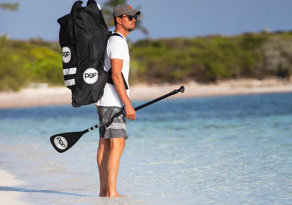 Backcountry Sportsman 11-foot Yacht Hopper inflatable stand-up paddleboard with mint, teak, and blue design, displayed in a protective bag.