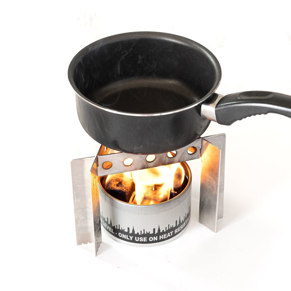 Portable Camp Stove by City Bonfires on a stand, designed for outdoor cooking and camping adventures.