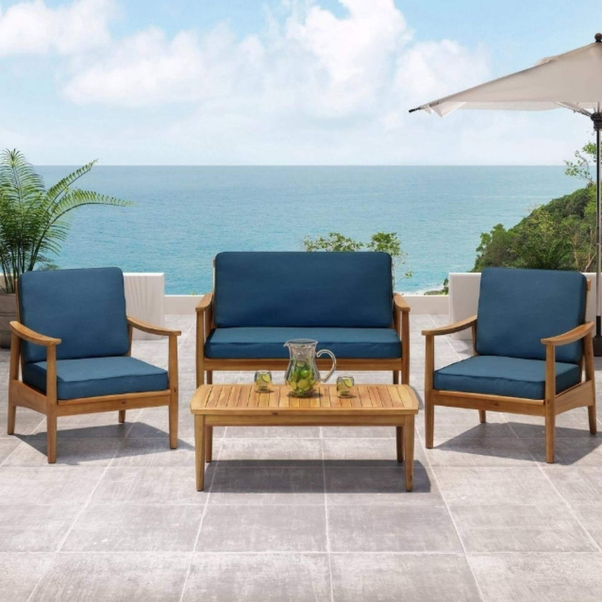 Alora 4-piece wooden outdoor patio seating set with cushions, showcasing stylish conversation area in a garden setting.