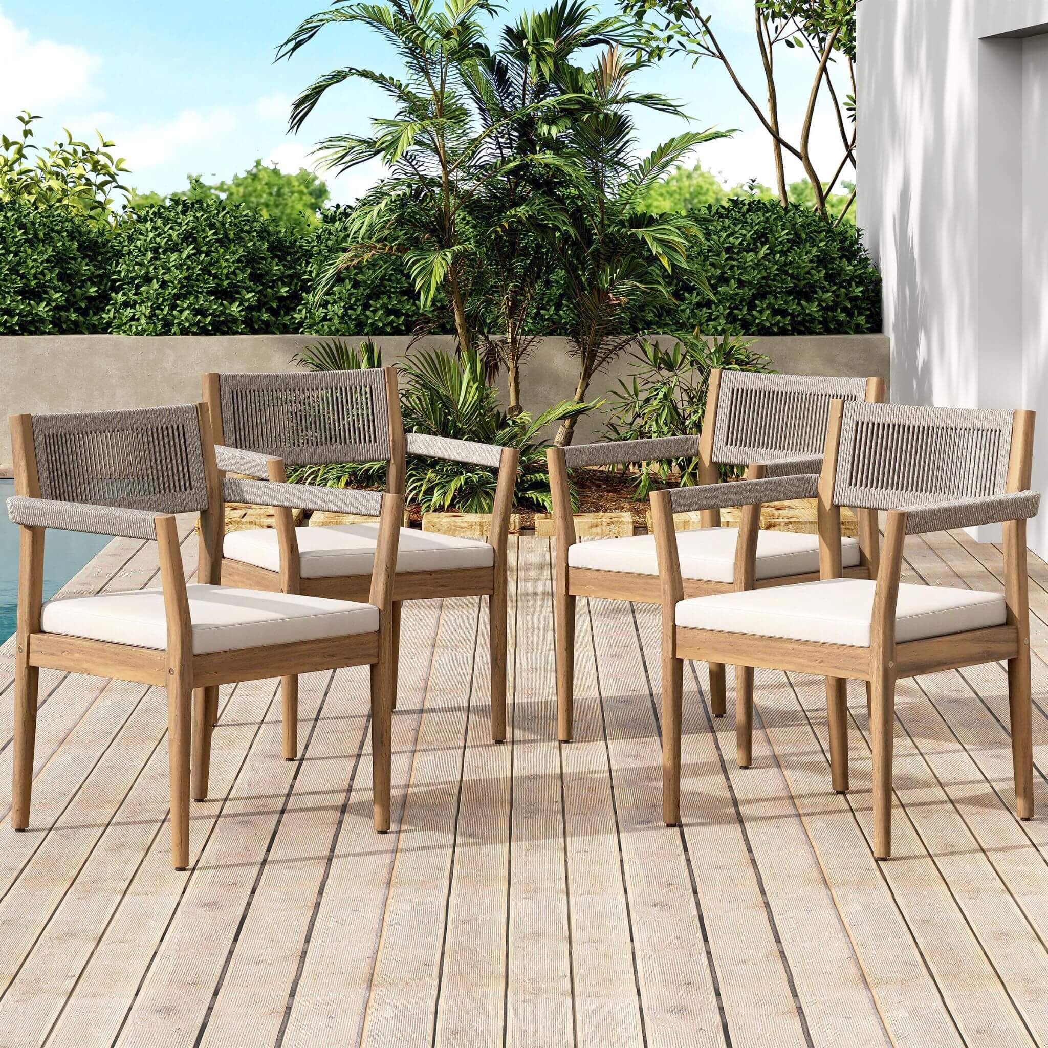 5-piece outdoor acacia wood patio furniture set with braided dining chairs and cushions, arranged around a dining table.