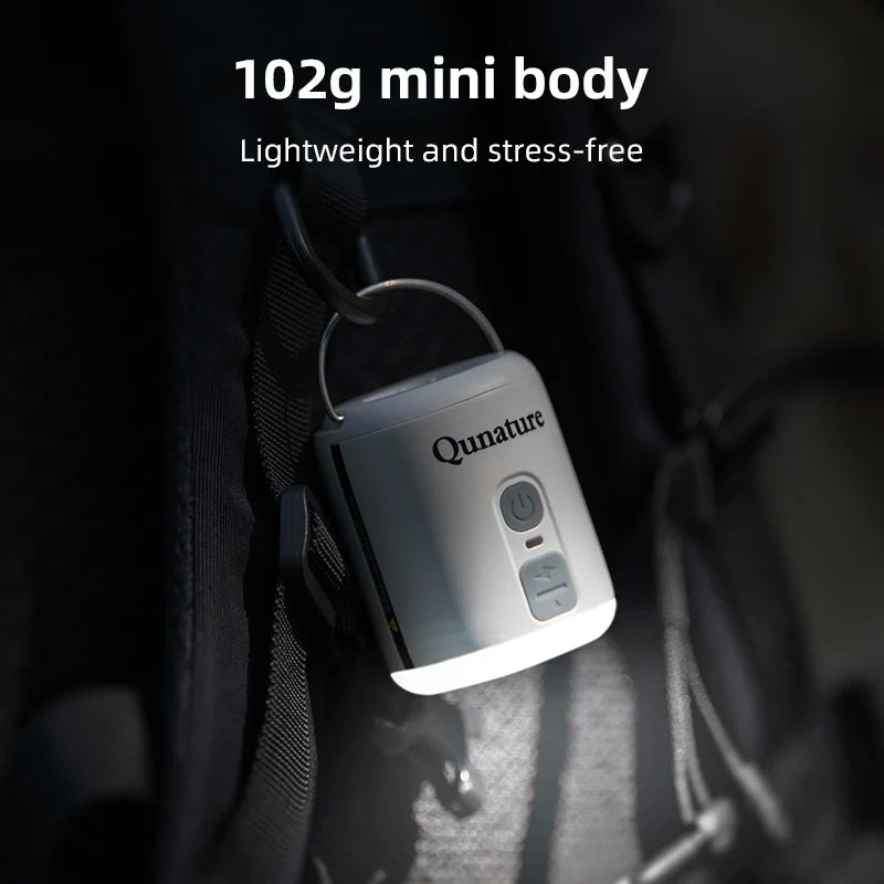 Qunature Global 4.5KPa Mini Air Pump with 1600mAh battery and integrated camping light on a white background.