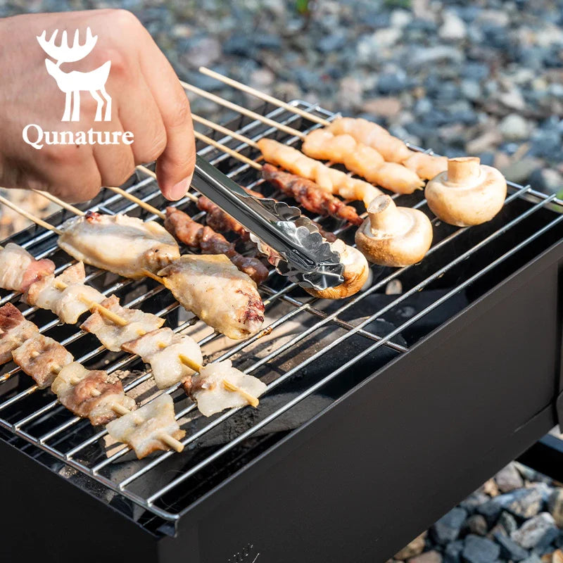 Foldable Qunature Global BBQ grill stove with chrome-plated net and ventilation, compact and portable for outdoor grilling.