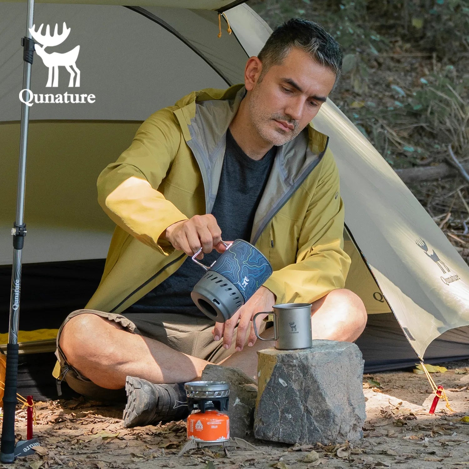 Qunature Global integrated heat collection stove system for camping, hiking, and outdoor adventures in natural setting.