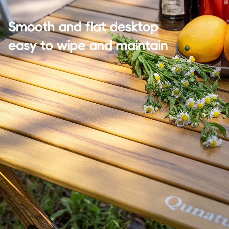 Lightweight foldable aluminum table by Qunature Global, showing a portable, sturdy table with a smooth surface and foldable legs.