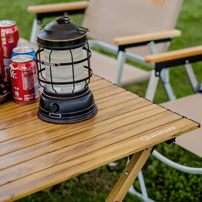 Qunature Global lightweight foldable aluminum table set up on a surface, showing its portable, foldable design and sleek aluminum construction.