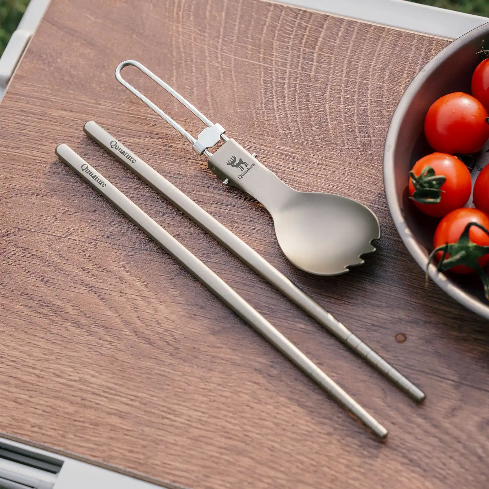 Lightweight titanium 3-in-1 tableware set by Qunature Global featuring a fork, spoon, and knife in a compact design.