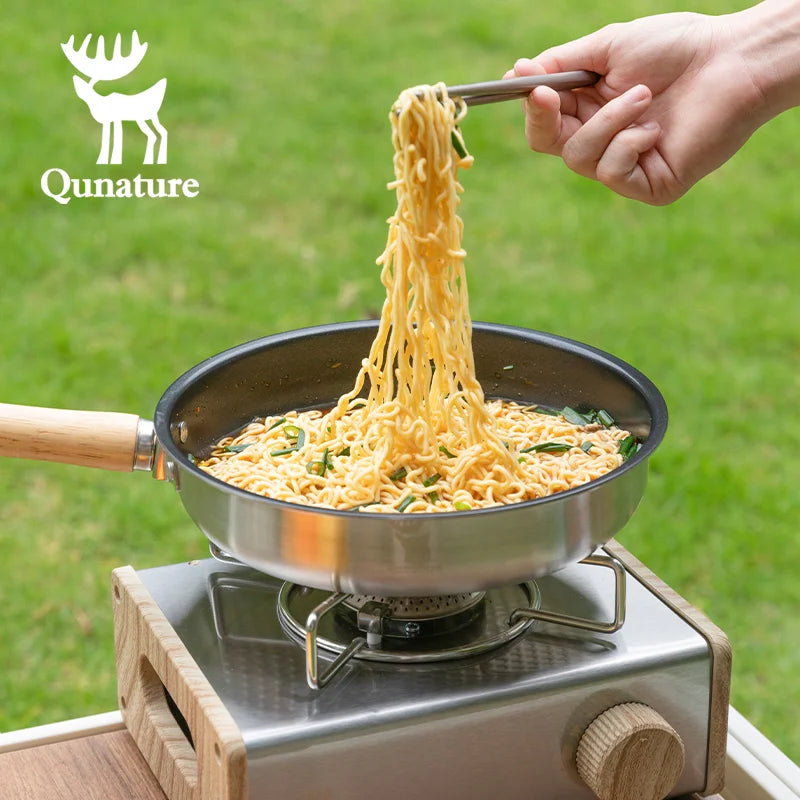 Non-stick stainless steel frying pan with detachable handle by Qunature Global, showing the smooth cooking surface and sturdy handle.