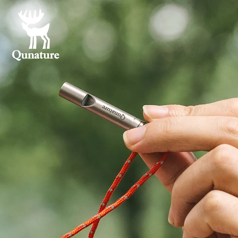 Qunature Global titanium survival whistle emitting a loud 120dB sound, compact and durable outdoor gear for emergency use.