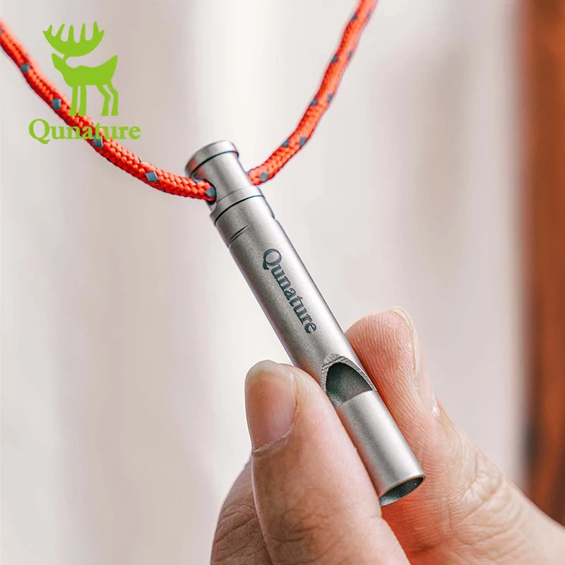 Qunature Global titanium survival whistle emitting a loud 120dB sound, compact and durable outdoor gear for emergency signaling.