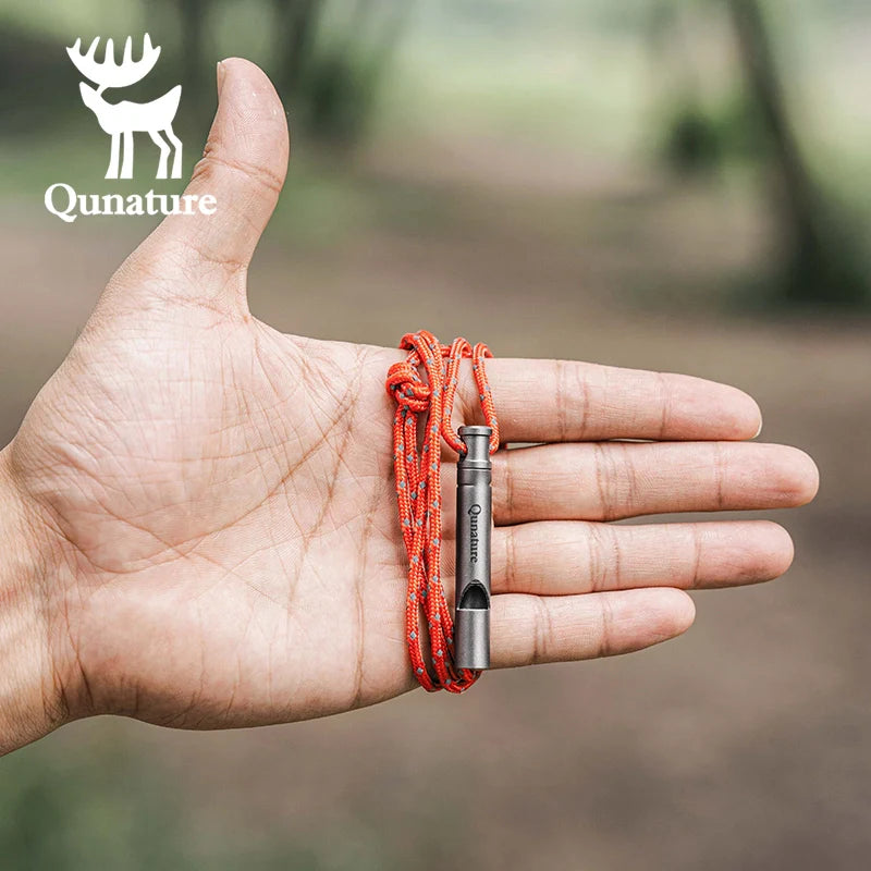 Qunature Global titanium survival whistle producing a loud 120dB sound, compact and durable outdoor gear for emergency use.