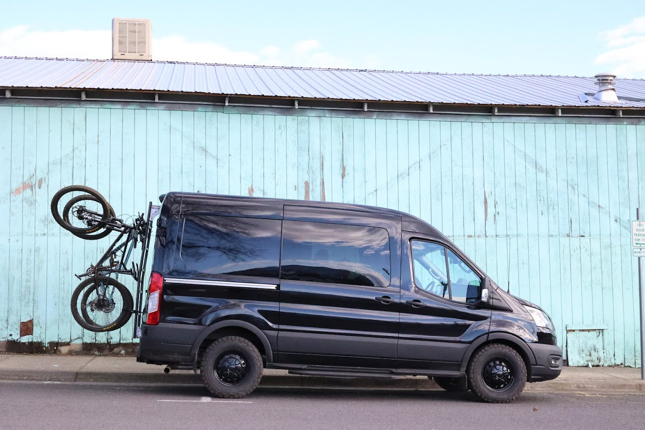 Lolo Racks Rad Lad rear ladder bike rack kit installed on a Ford Transit van, showing the mounted bike rack on the rear ladder.