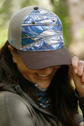 Rainbow Ridge Abstract Trucker Hat by FisheWear featuring a colorful, artistic design on a classic trucker hat style.
