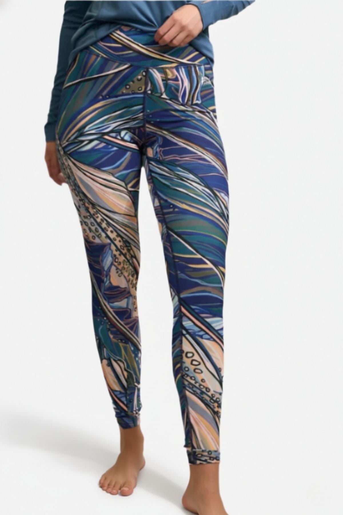 FisheWear Rainbow Ridge high-waisted leggings with colorful rainbow pattern and comfortable fit, shown on a model.