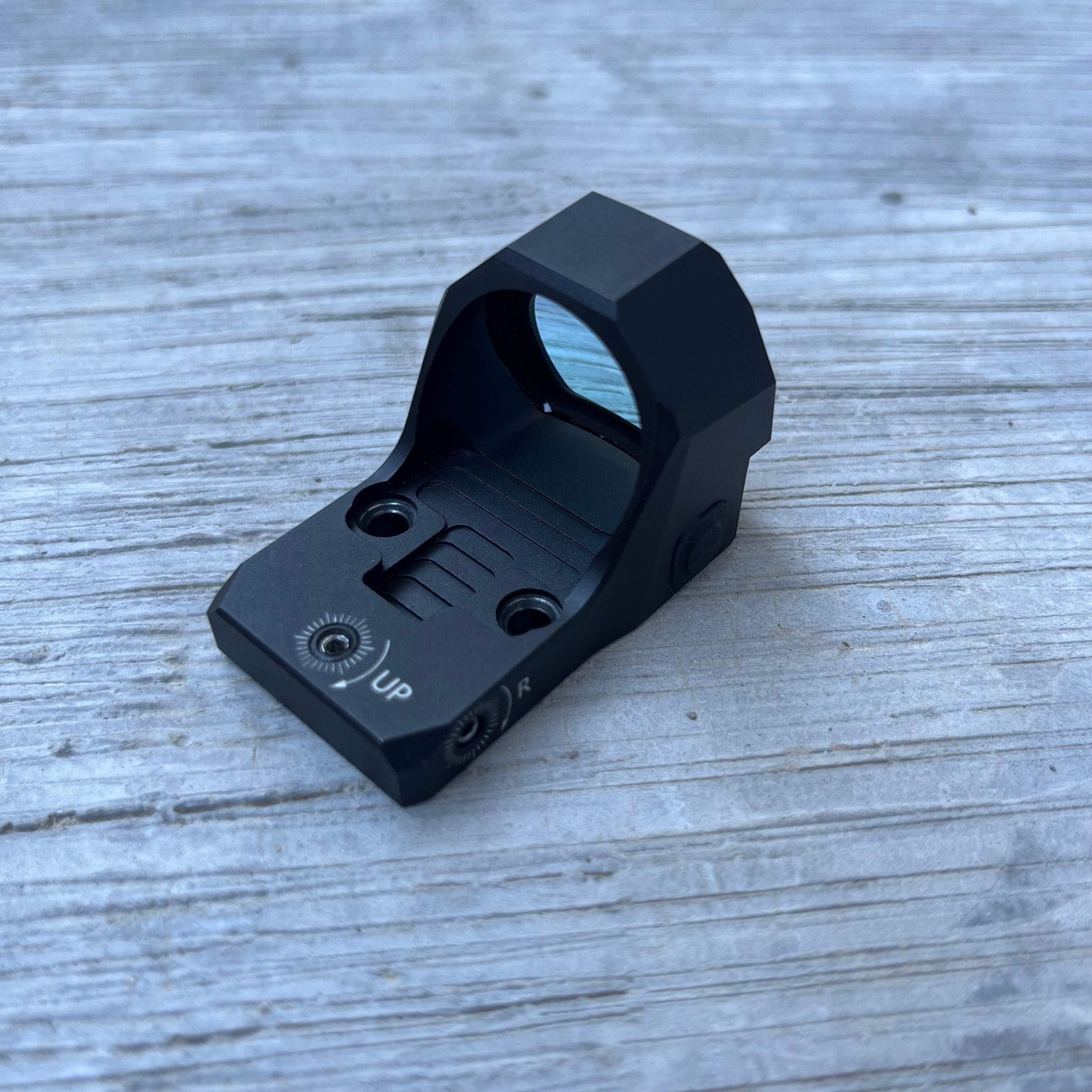 SFT2 Tactical Regulator MRS red dot sight on a black background, showcasing its compact design and lens clarity.