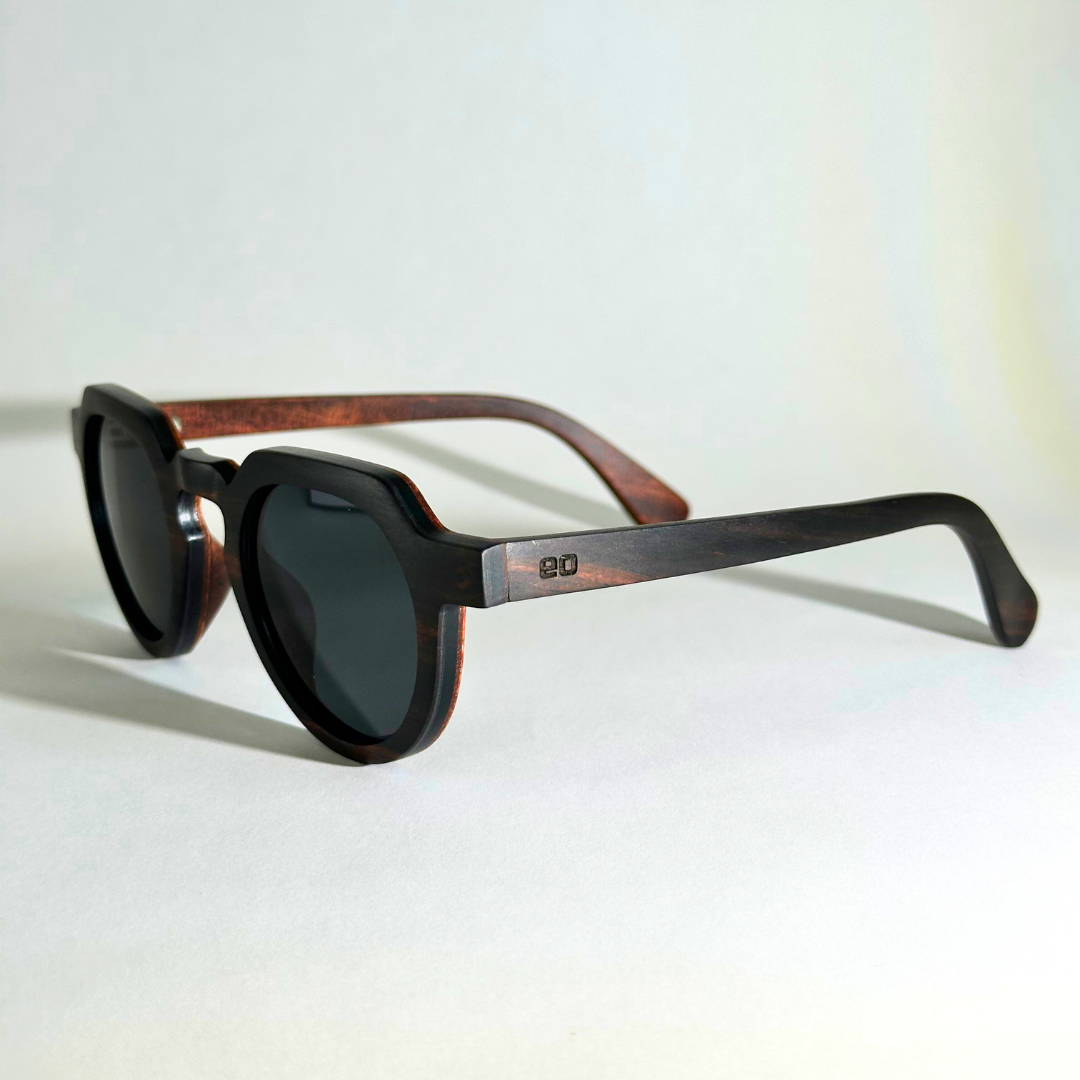 Eastern Outer Wallsburg sunglasses with round wood and carbon fiber frames, shown from a left-angle view.