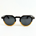 Eastern Outer Wallsburg sunglasses with round yellow lenses and a sleek wood and carbon fiber frame.