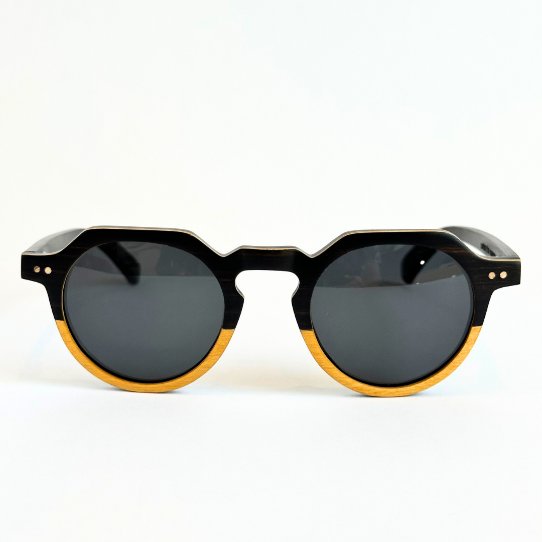 Eastern Outer Wallsburg sunglasses with round yellow lenses and a sleek wood and carbon fiber frame.
