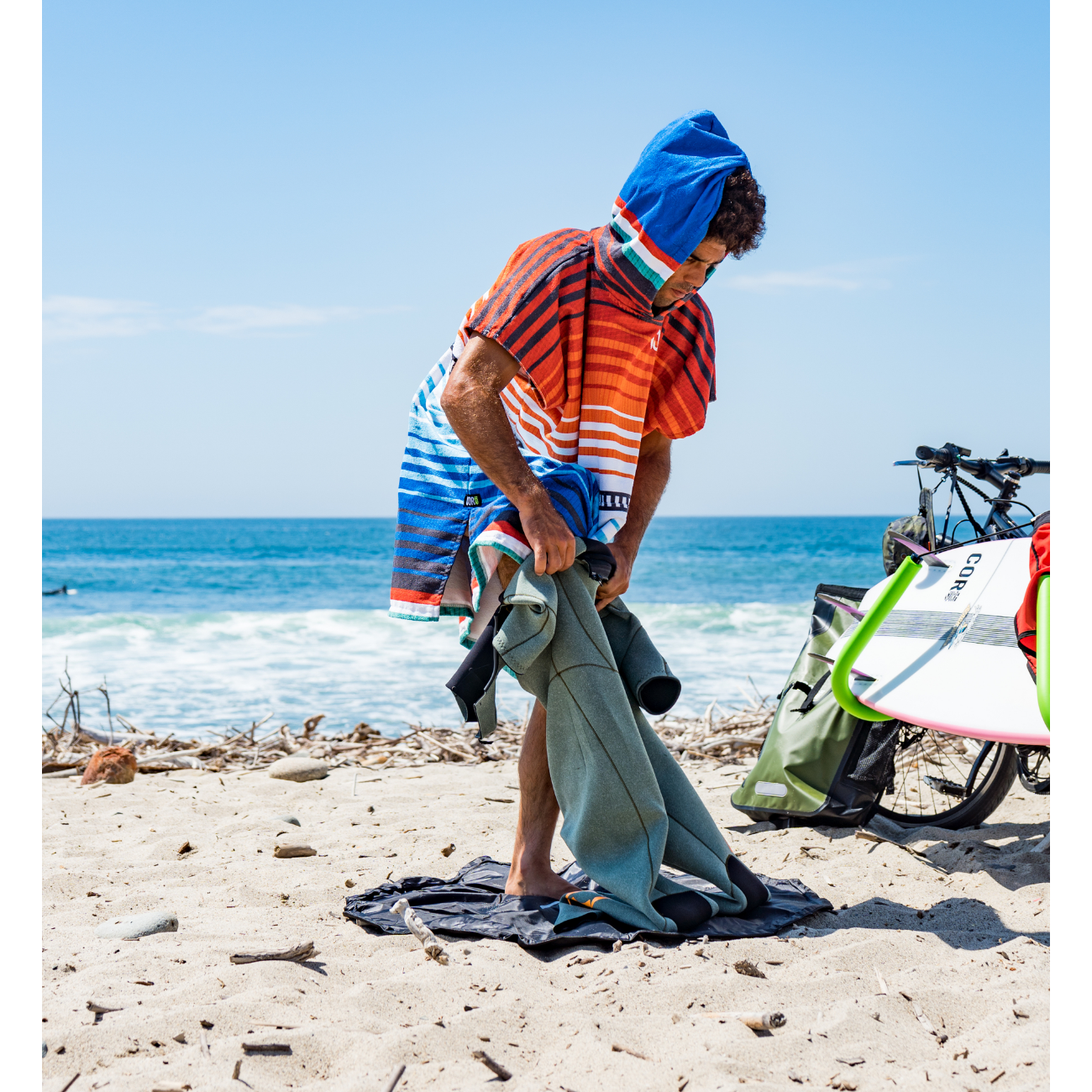 Adult large COR Surf changing towel poncho made of colorful sarape fabric, designed for beach and outdoor use.