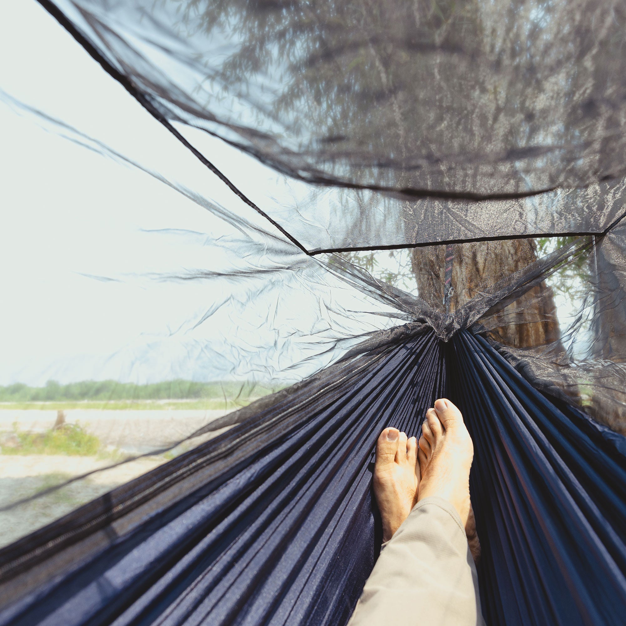 GrandTrunk Skeeter Beeter XT mosquito net hammock set up outdoors, showcasing its protective netting and comfortable design.