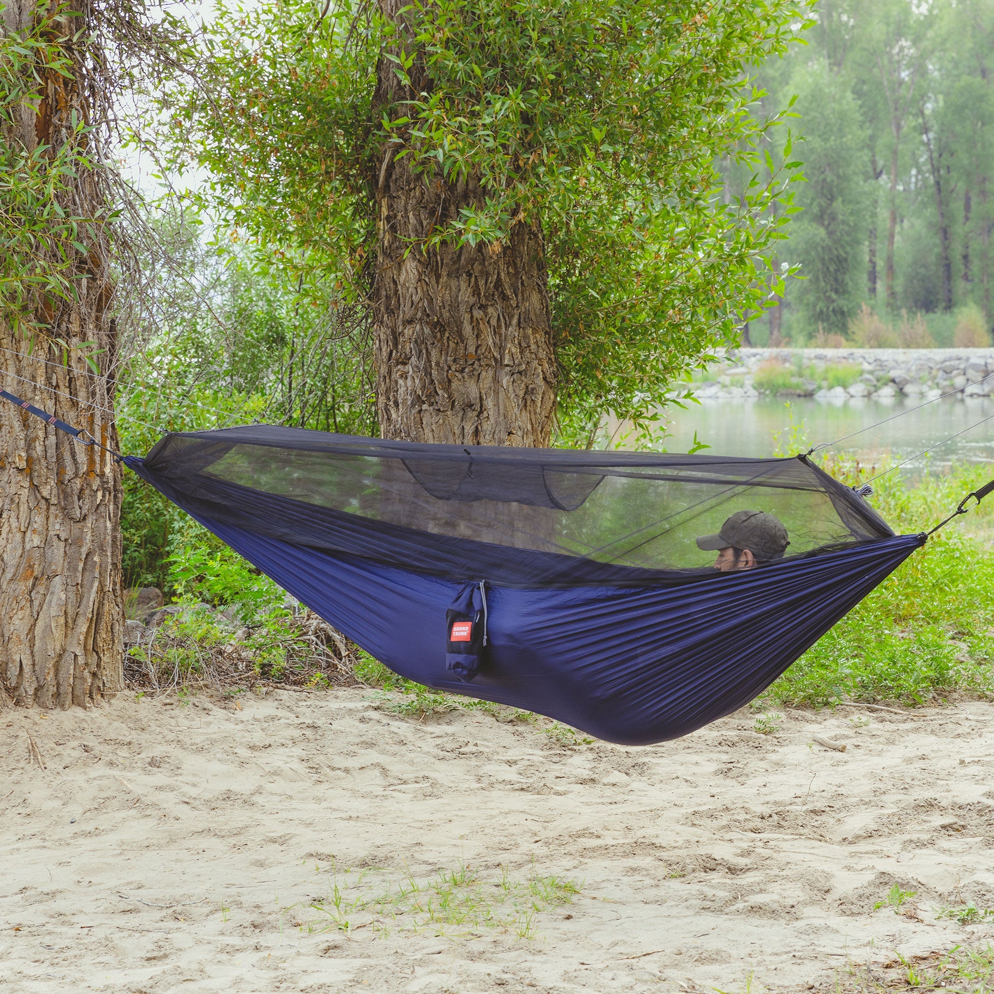 GrandTrunk Skeeter Beeter XT Mosquito Net Hammock set up outdoors, showcasing its protective netting and hammock design.