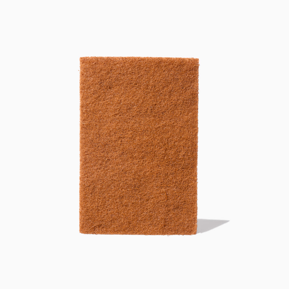 Public Goods household scouring pad with textured surface for effective cleaning, shown front view for kitchen use