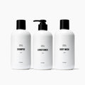 Public Goods Shower Essentials Set with shampoo, conditioner, body wash, and skincare products on a clean bathroom surface.