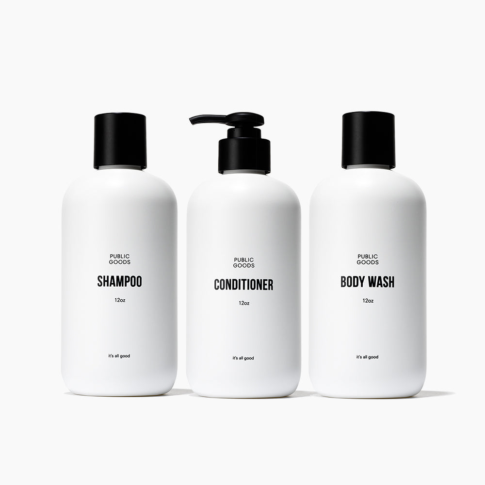 Public Goods Shower Essentials Set with shampoo, conditioner, body wash, and skincare products on a clean bathroom surface.