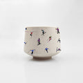 Mini ceramic skier cup by Artsy Em's Designs featuring a colorful skier illustration on a white background.