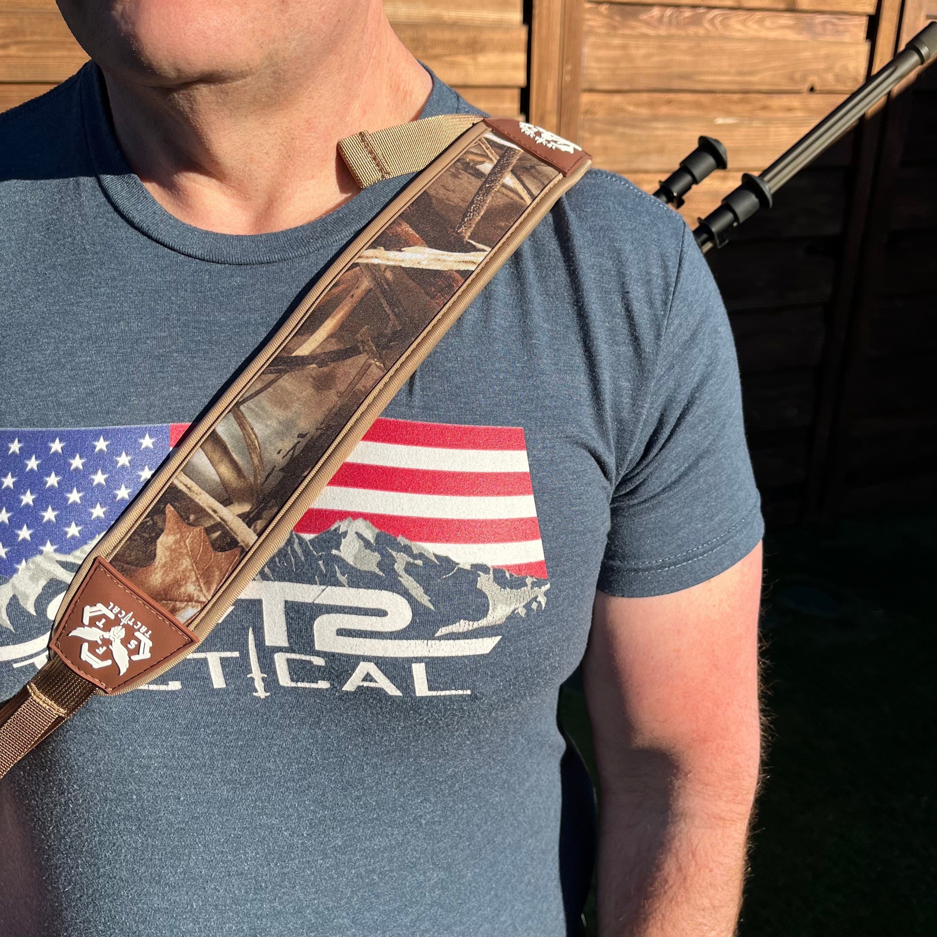 SFT2 Tactical hunting sling attached to a rifle, adjustable strap for comfortable carrying during outdoor hunting activities.