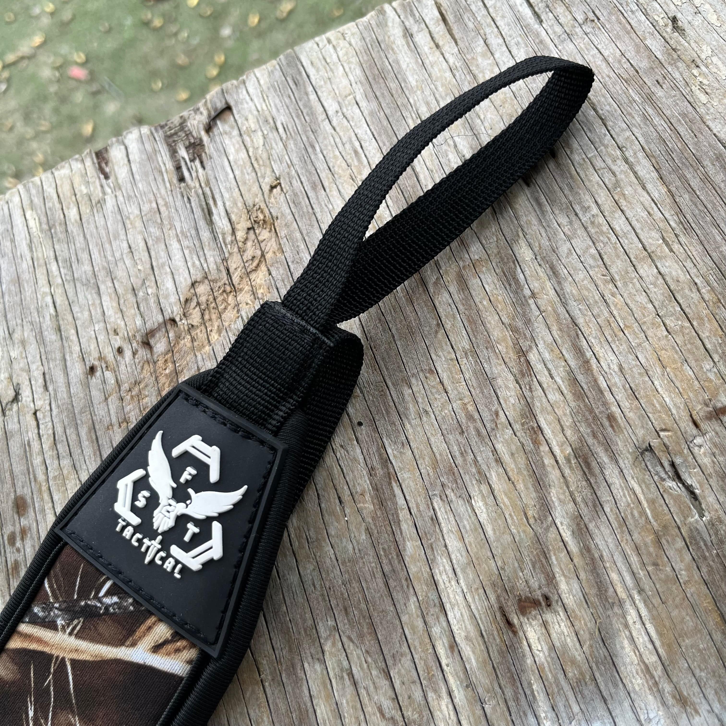 SFT2 Tactical hunting sling attached to a rifle, featuring adjustable straps and durable construction for outdoor shooting.