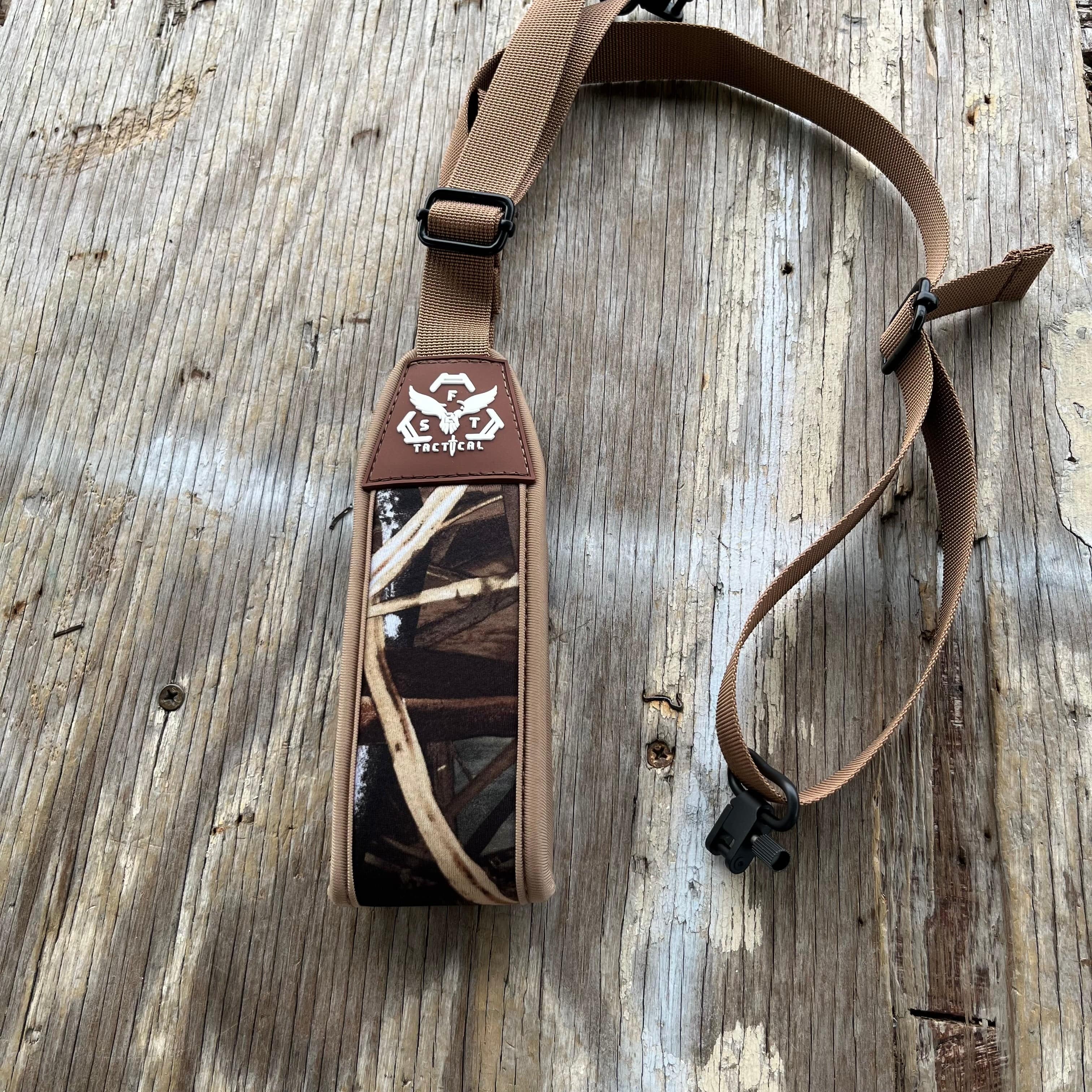 SFT2 Tactical hunting sling attached to a rifle, adjustable strap for secure firearm carrying during outdoor hunting activities.