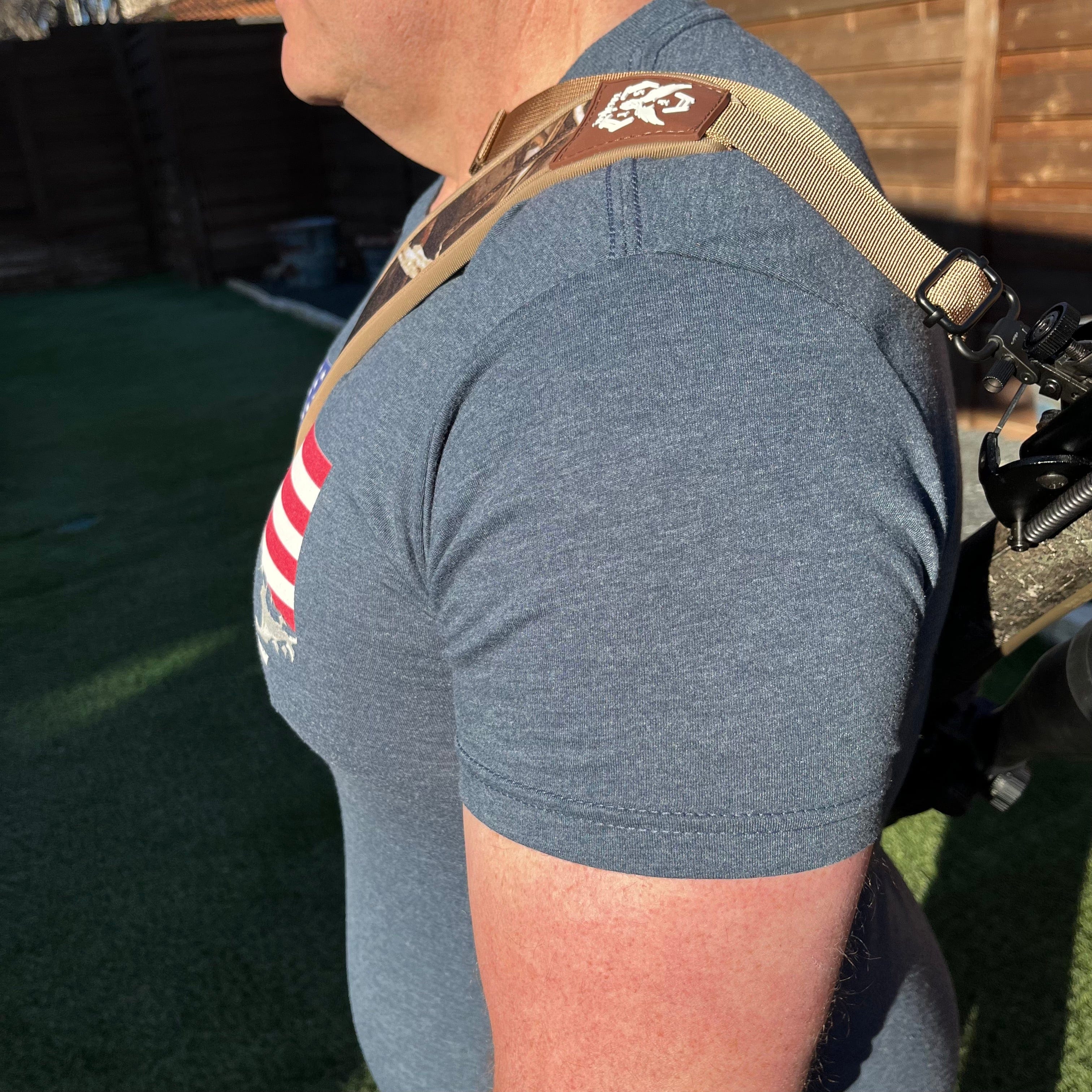 SFT2 Tactical hunting sling attached to a rifle, adjustable strap for secure carrying during outdoor hunting activities.