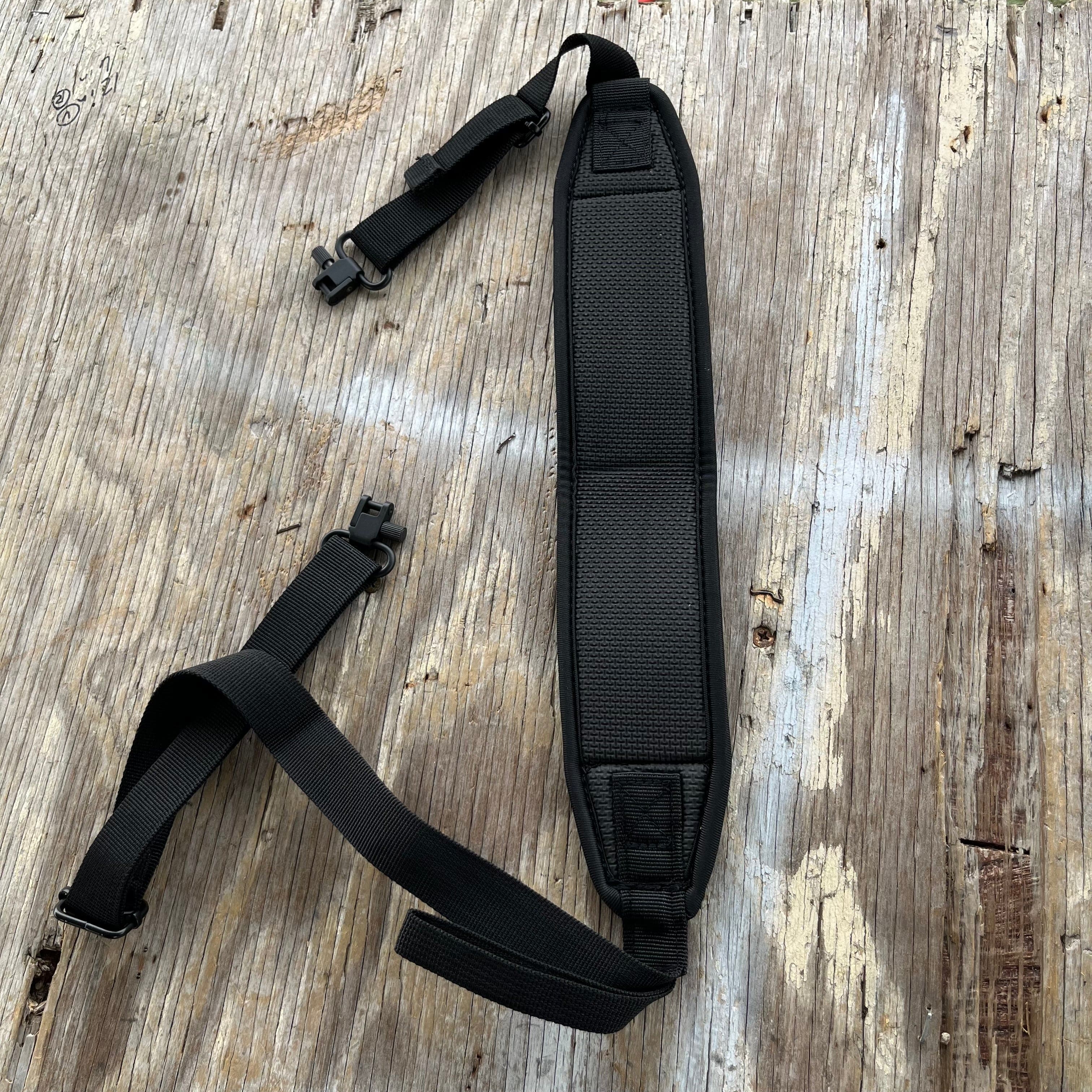 SFT2 Tactical hunting sling attached to a rifle, adjustable strap with quick-release buckle, designed for secure firearm carrying.