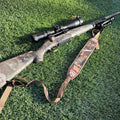 SFT2 Tactical hunting sling attached to a firearm, adjustable strap for secure carry and quick access during outdoor hunting activities