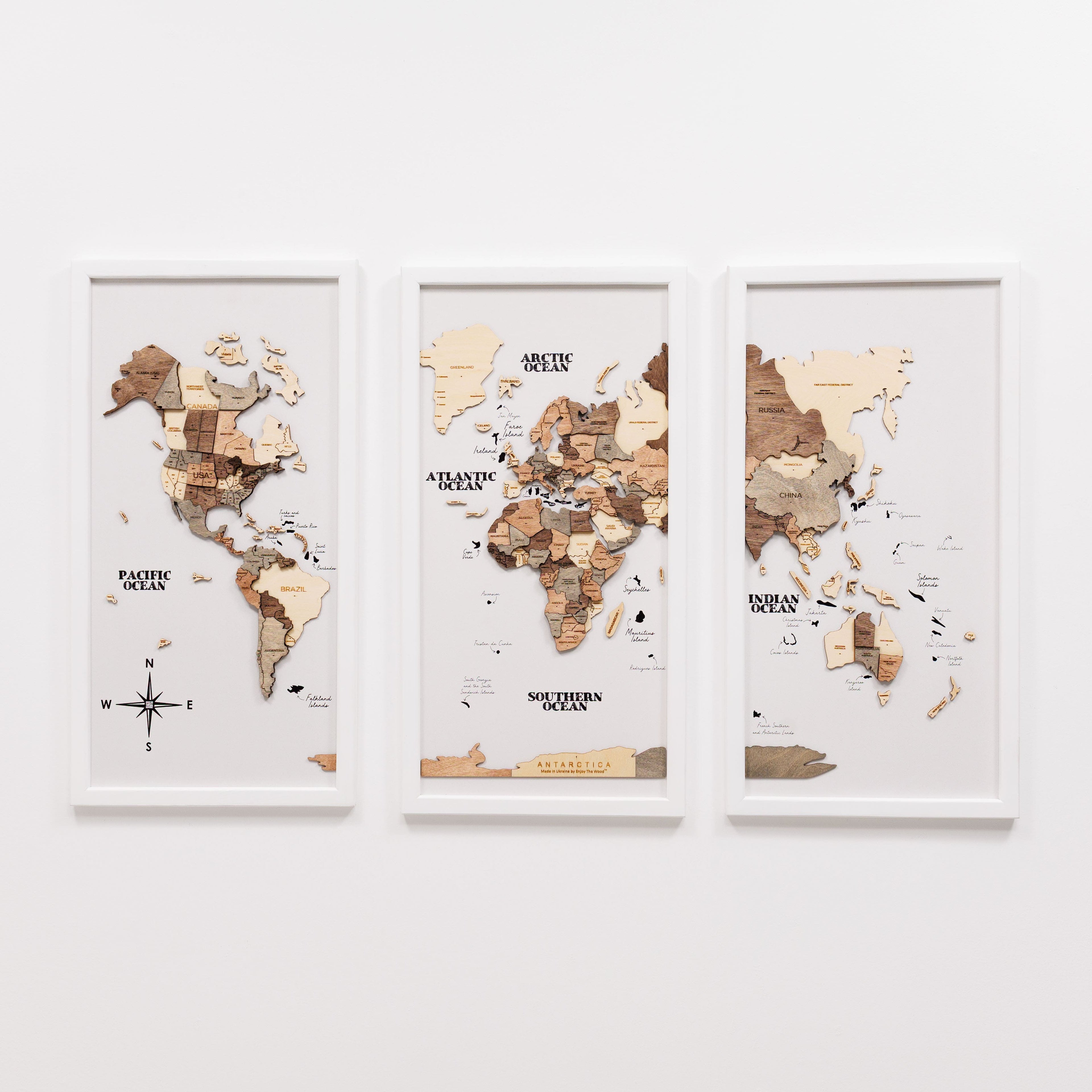 Wooden triptych wall art of a smoky world map by Enjoy The Wood, showing detailed wooden continents and ocean design.
